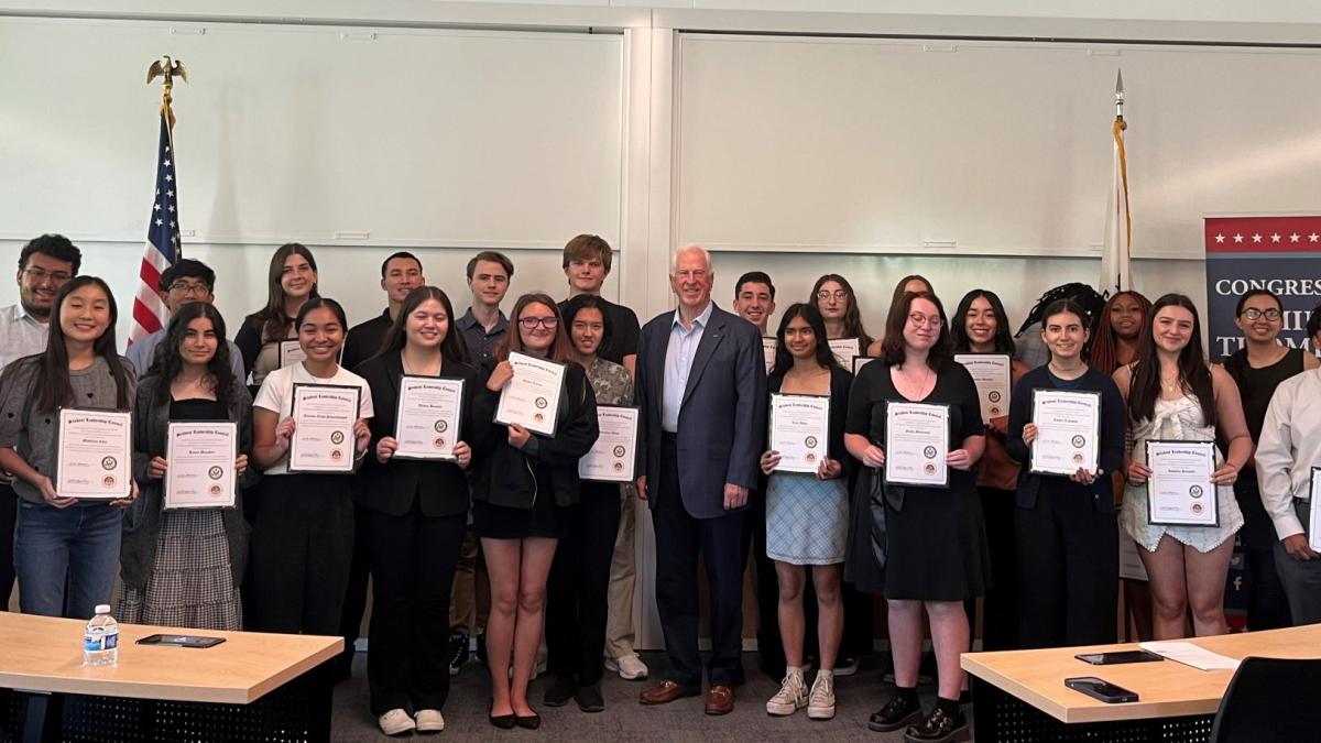 Photo of Rep. Thompson standing with Student Leadership Council graduates holding certificates