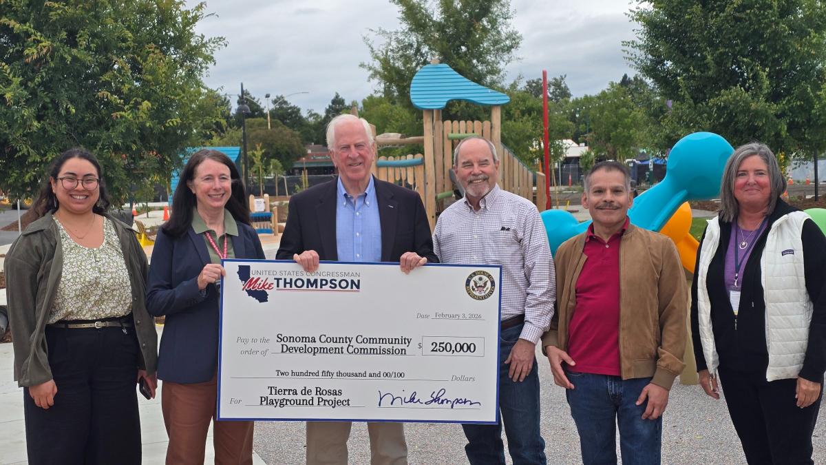 Group photo with Rep. Thompson holding a check 