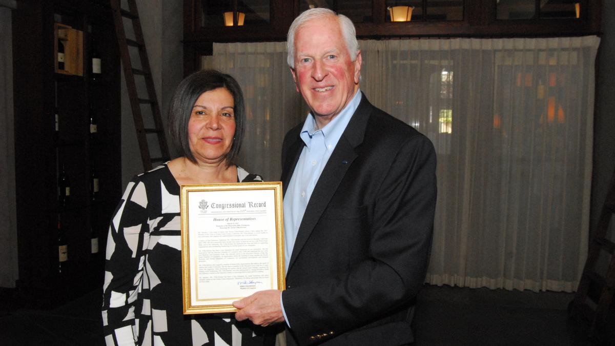 Rep. Thompson presents a certificate of Congressional recognition to Villa  Serrano.