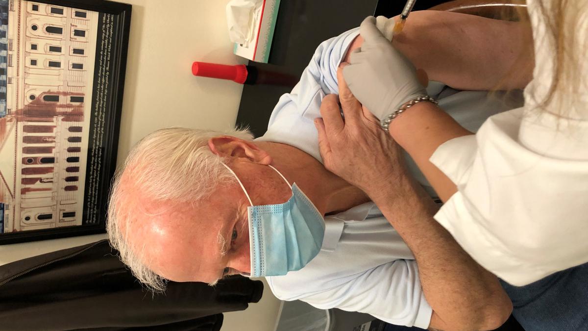 Photo of Thompson receiving COVID  19 vaccine