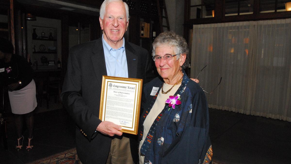 Rep. Thompson presents a certificate of Congressional recognition to Lyon.
