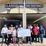 Re. Thompson with members of Clarksburg Fire Protection District holding a large check