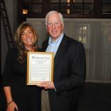 Rep. Thompson presents a certificate of Congressional recognition to Rubinoff.