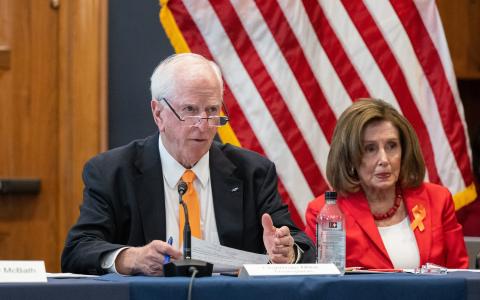 Photo of Rep. Thompson sitting next to Speaker Emerita Pelosi