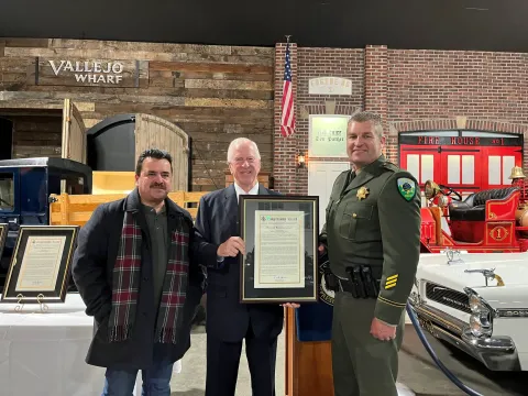 Rep. Thompson stands with Officer Deguilio and the Congressional Record Statement