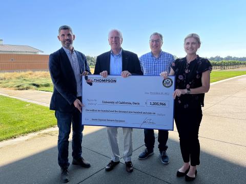 Photo of Rep. Mike Thompson presenting a check to Dr. Anita Oberholster and her team at the University of California, Davis