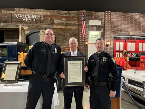 Rep. Thompson stands with Officer Eagle and the congressional record statement