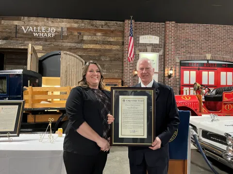 Rep. Thompson stands with Chrissy Valadez and the congressional record statement