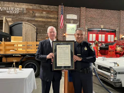 Rep. Thompson presents Chief Farrow with the Congressional Record Statement