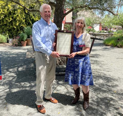 Photo of Rep. Thompson presenting CRS to Denise Rushing