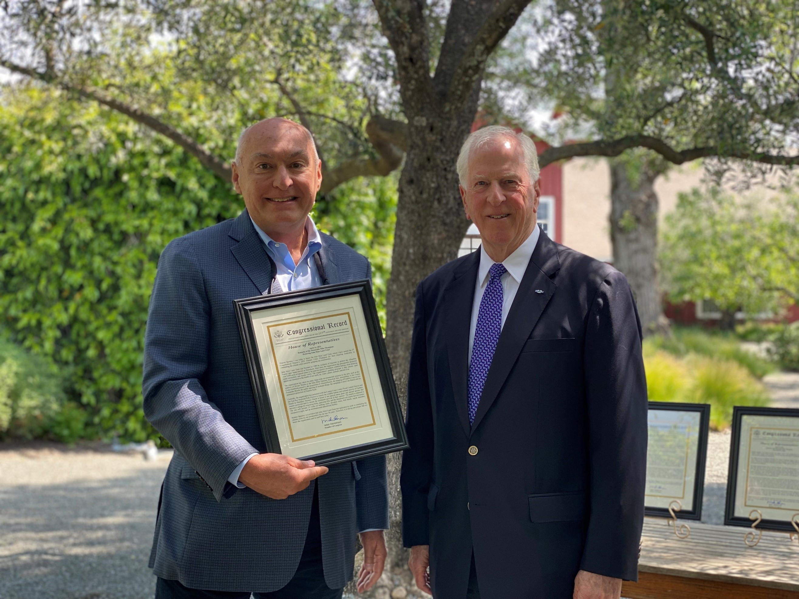 Rep. Thompson presenting the award to John Muir Land Trust Executive Director Linus Eukel